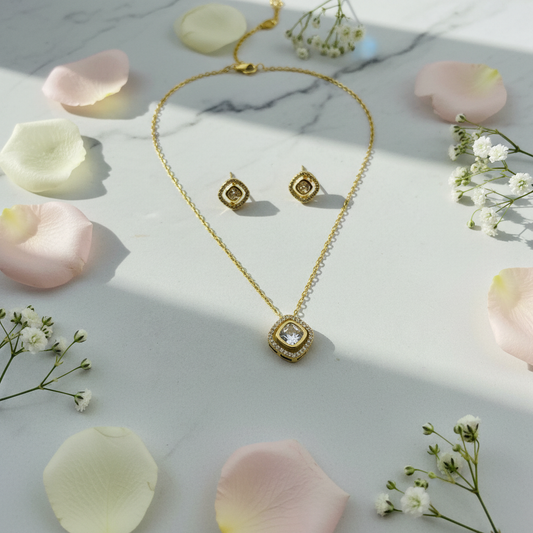 Cushion jewelry set on marble with roses at angle