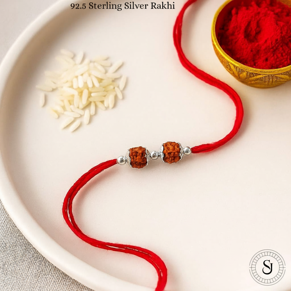 Sparsh Jewel Double Rudraksha Rakhi on white plate with kumkum and rice