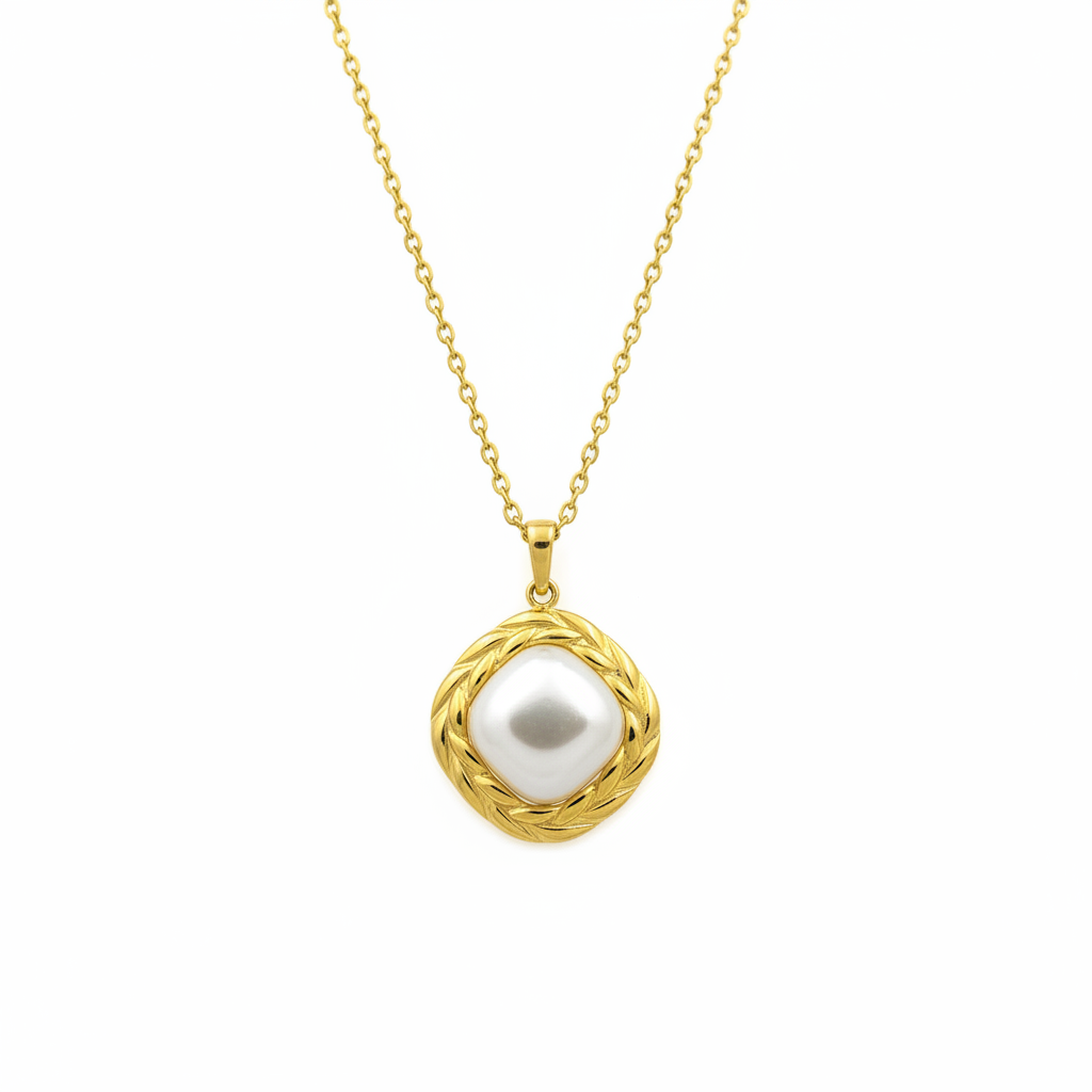 Pearl pendant with braided gold frame on white background