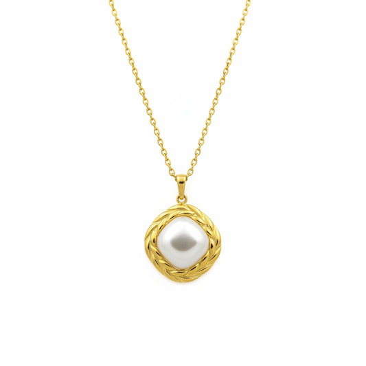 Pearl pendant with braided gold frame on white background