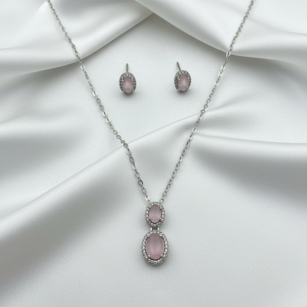 Rose quartz jewelry set on white silk with high-key lighting